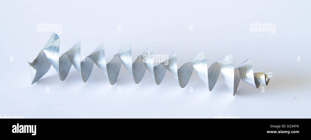 A beautiful metal strand on a light background. Metalworks details. Stock Photo