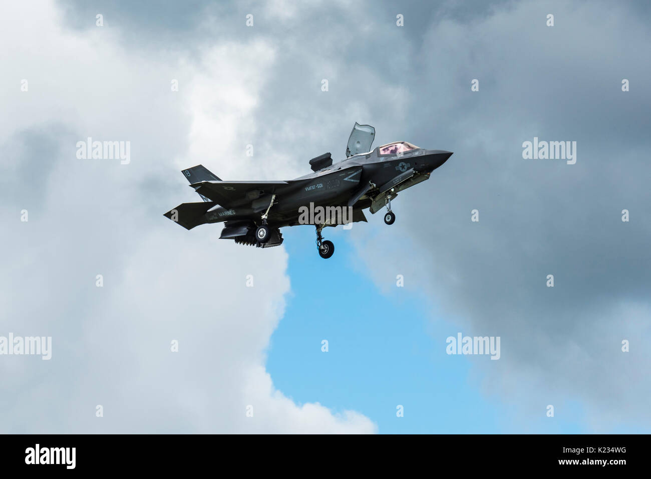 The Lockheed Martin F-35B Lightning II in Farnborough, Hampshire, UK showing off it's flexibility in the skies by hovering over the runway. Stock Photo