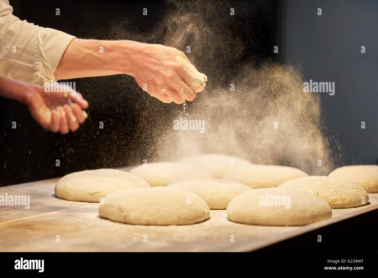 chef or baker cooking dough at bakery Stock Photo