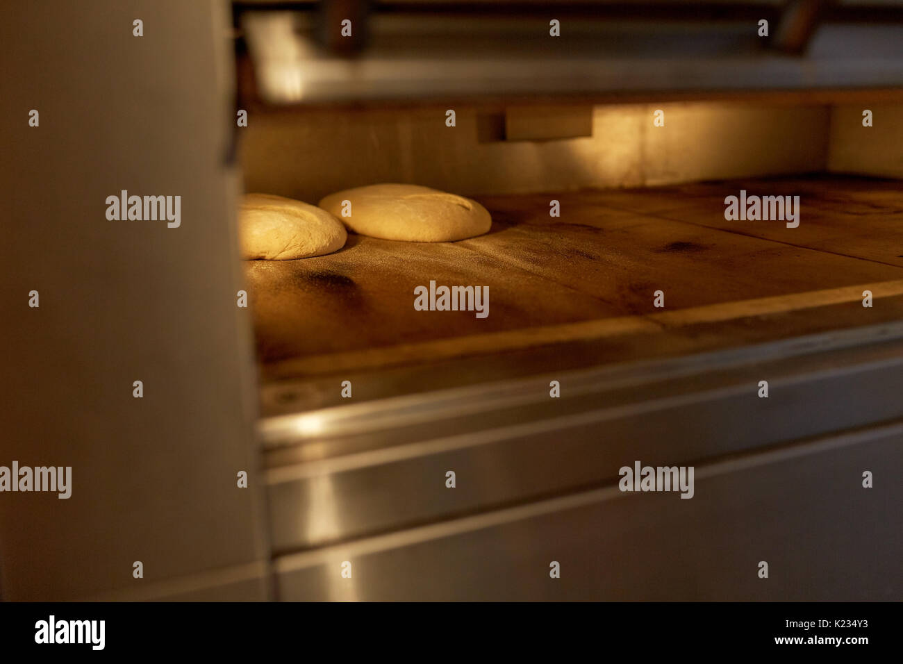 yeast bread dough in oven at bakery kitchen Stock Photo - Alamy