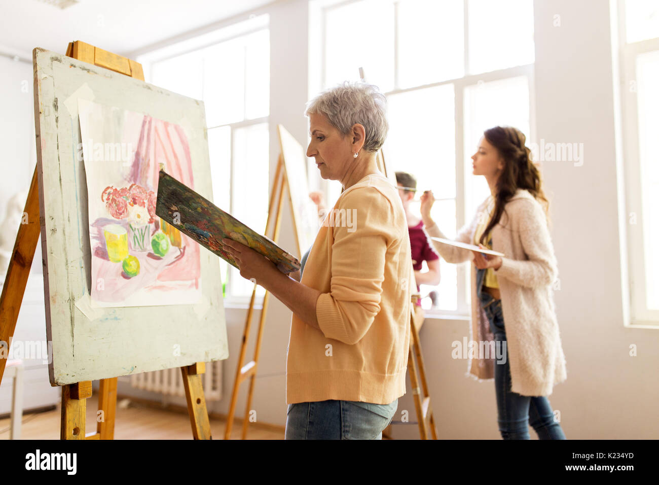 woman artist with easel painting at art school Stock Photo Alamy — free download