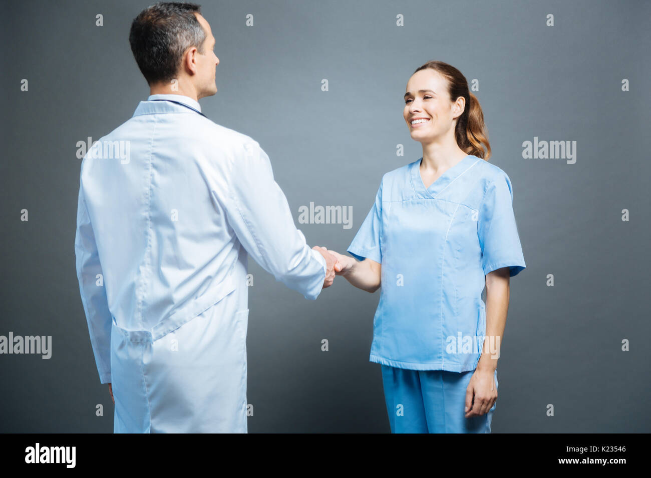 Friendly medical professionals shaking hands Stock Photo Alamy