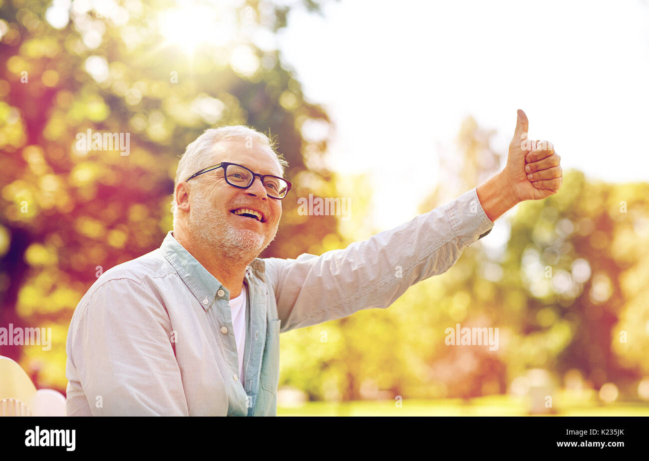 happy senior man showing thumbs up at summer park Stock Photo