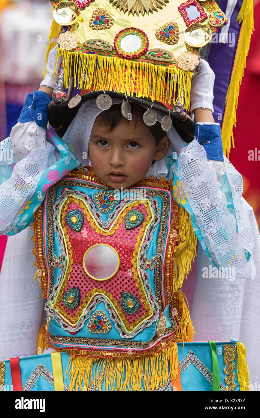 June 17, 2017 Pujili, Ecuador: indigenous quichua young boy wearing a colourful costume and headdress at the Corpus Christi annual parade Stock Photo