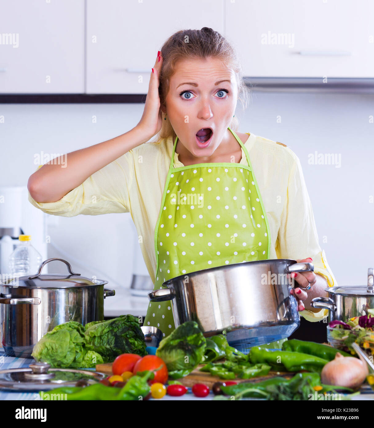 https://c8.alamy.com/comp/K23B96/stressed-housewife-trying-unpatable-meal-at-kitchen-K23B96.jpg