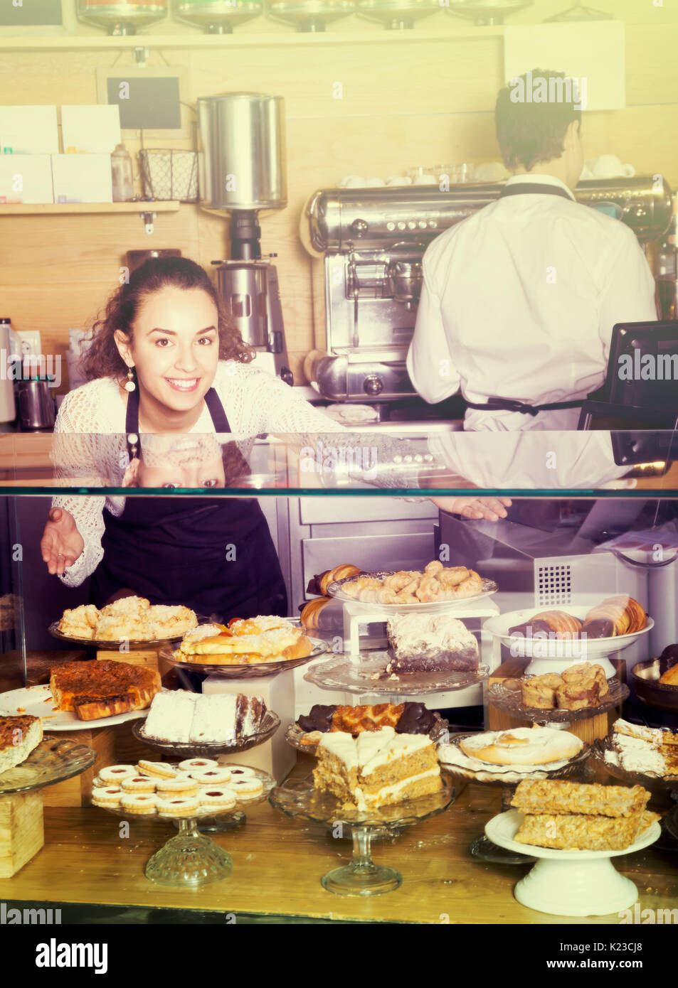 Hospitable girl offering delicious cream pies at bakery Stock Photo Alamy