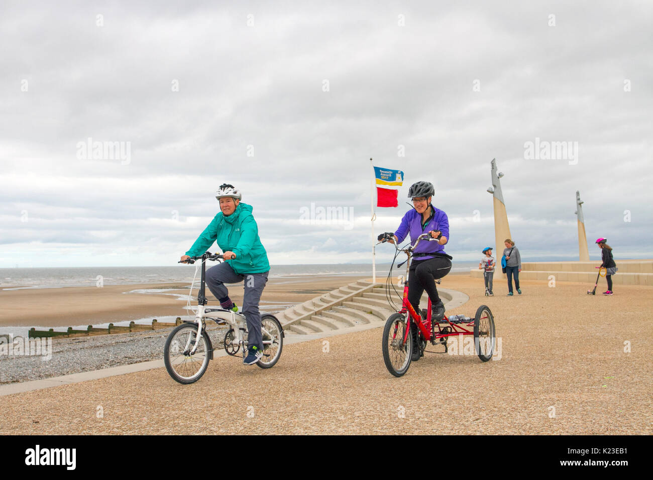 Thorton-Cleveleys, Backpool. UK Weather. 28th August, 2017. Windy and overcast day in the resort as the expected high temperatures for the August Bank Holiday do not materialise on the north-west coast. The seafront is largely deserted apart from people taking exercise on the Jubilee Beach Promenade. Credit; MediaWorldImages/AlamyLiveNews. Stock Photo