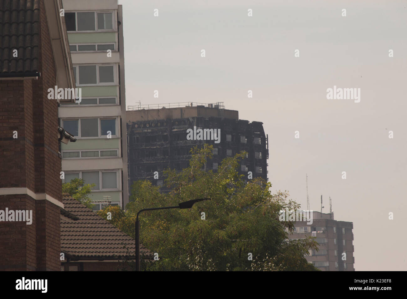 London, UK. 28th Aug, 2017. 28th August 2017. People enjoying themselves in Notting Hill carnival with Grenfell tower in the background. Credit: Sebastian Remme/Alamy Live News Stock Photo