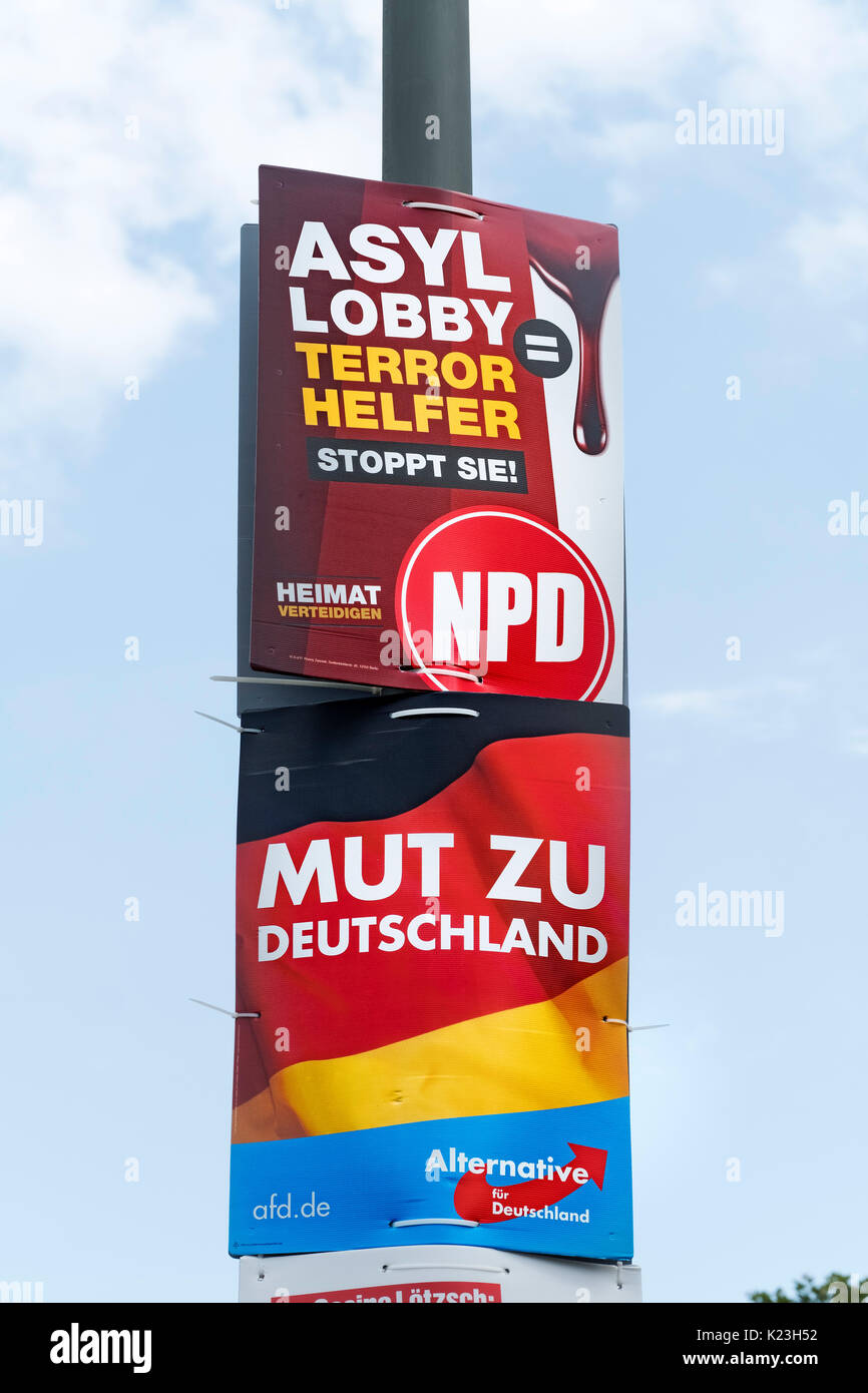 Berlin, Germany. 28th August 2017. Party political posters for far-right neo-Nazi NPD party, National Democratic Party of Germany (top) with message, 'Asylum Lobby are Terrorist Helpers', and the far-right Alternative for Germany party, AfD , with message 'Courage to Germany' in Eastern district of Berlin for Federal elections on 24th September 2017. Credit: Iain Masterton/Alamy Live News Stock Photo
