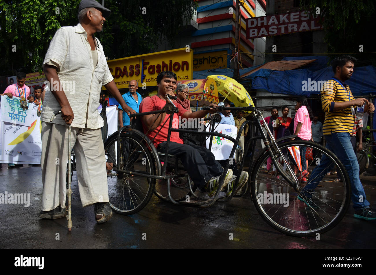 Calcutta,India,28th Aug'17.Helping each other to co-operate in the walk.This is walk is conducted by Civilian Welfare Foundation.The theme of the Walk this year is “Adopt a Para athlete” where an individual or group can support an athlete with disabilities starting from Rs1500/month for a year.The unique aspect of the walk is that it is first of its kind initiative in the world where disabled athletes, students,NGOs,activists,individuals and most importantly achievers at large,walk to champion the cause of Paralympics sports. Credit: Dipayan Bose/Alamy Live News. Stock Photo