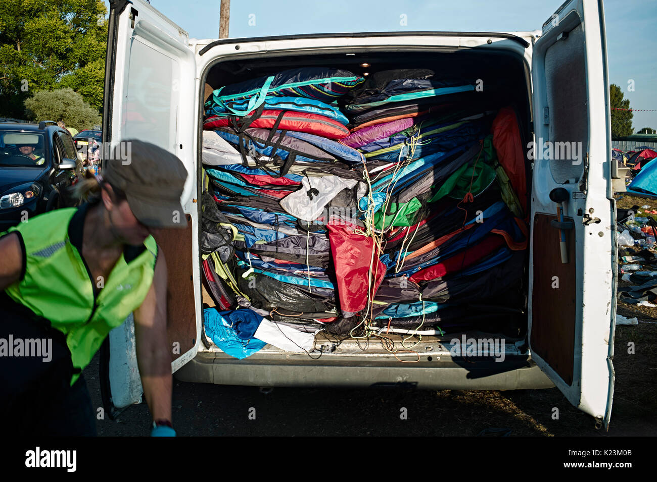 Reading, UK. 28th Aug, 2017.   Charity volunteers salvage tents and camping items to send to refugees in Calais and Dunkirk. The aftermath of Reading Festival start the huge clean-up operation begins.Thousands of revellers decided to ditch their tents in the fields following the bank holiday weekend rock festival. Over half a dozen fields where festival-goers camped are now littered with rubbish and abandoned tents. Credit: john angerson/Alamy Live News Stock Photo