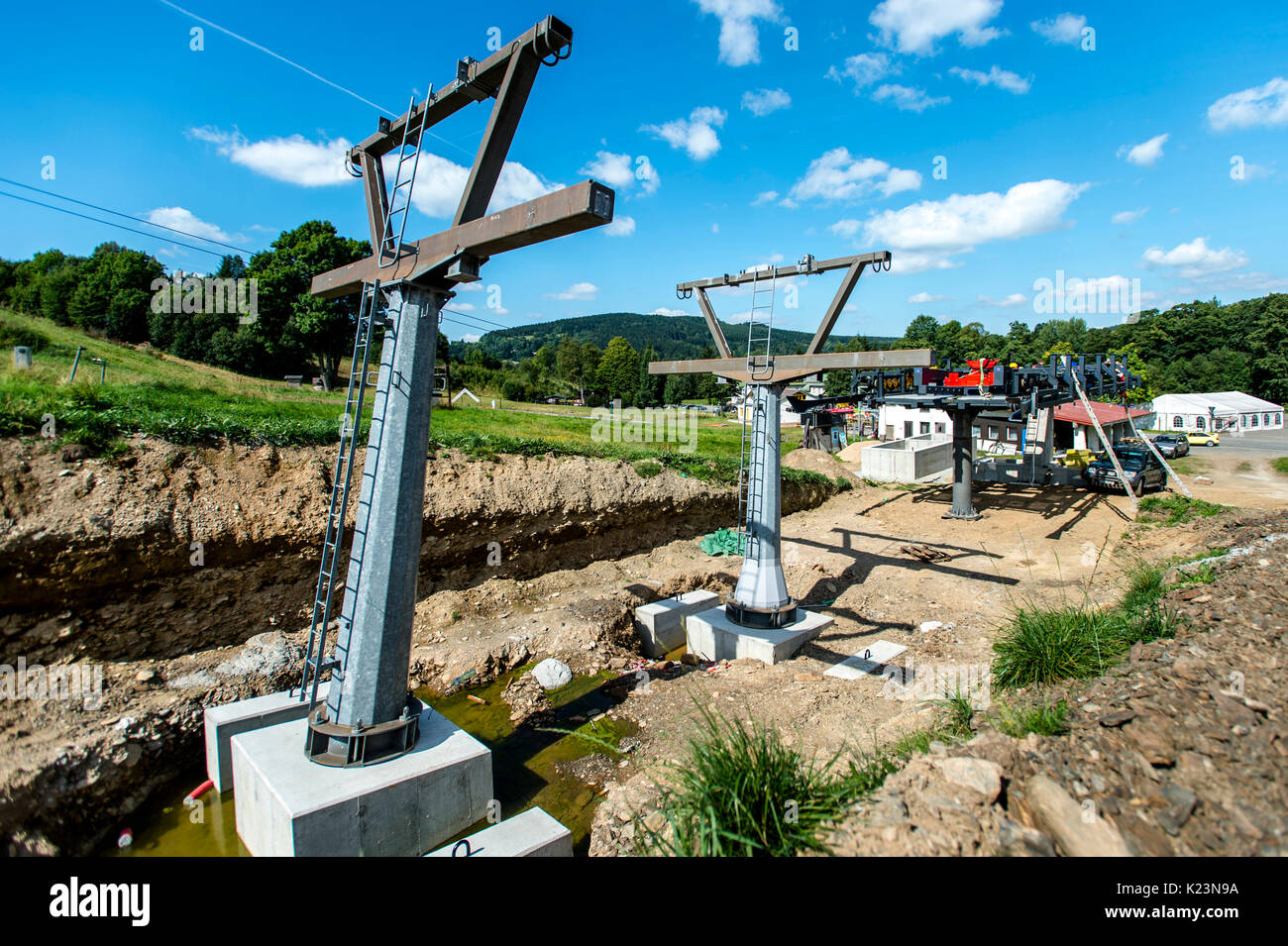 Ski center Destne v Orlickych horach is building the four-seat chairlift, for about 30 million crowns, in Destne v Orlickych horach, Czech Republic, on August 29, 2017. The upcoming winter season should increase a comfort of skiing in the Marta II area. The 865-meter chairlift can transported 2180 people per hour. (CTK Photo/David Tanecek) Stock Photo