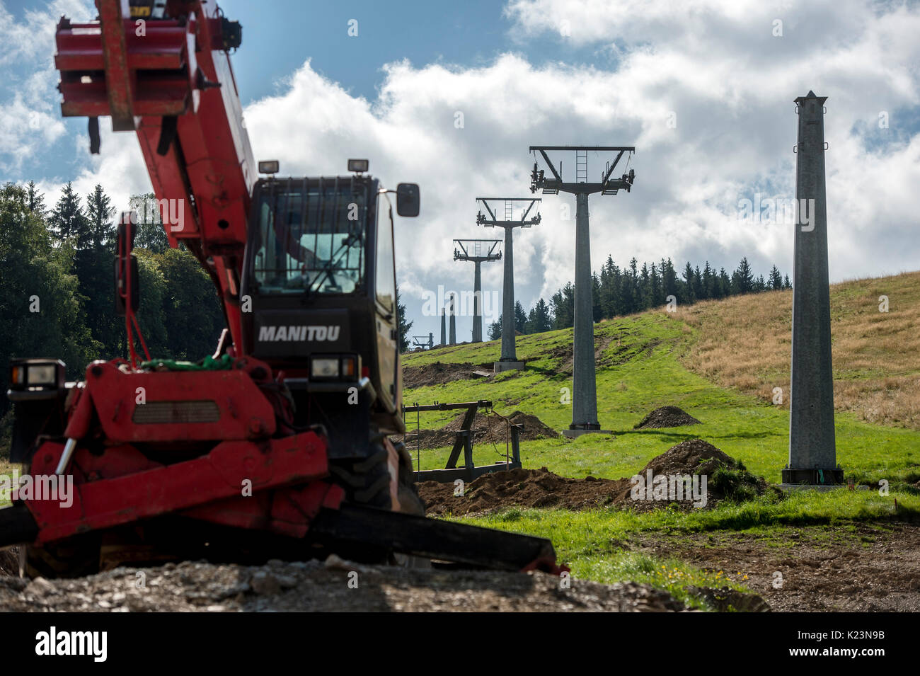 Ski center Destne v Orlickych horach is building the four-seat chairlift, for about 30 million crowns, in Destne v Orlickych horach, Czech Republic, on August 29, 2017. The upcoming winter season should increase a comfort of skiing in the Marta II area. The 865-meter chairlift can transported 2180 people per hour. (CTK Photo/David Tanecek) Stock Photo