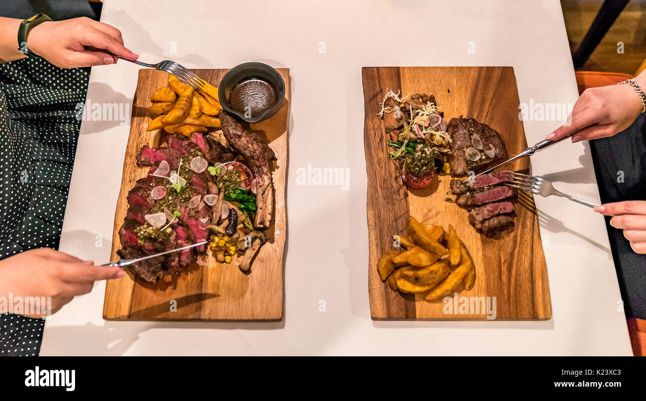Top View of Steak and Hand with fork and table knife Stock Photo - Alamy