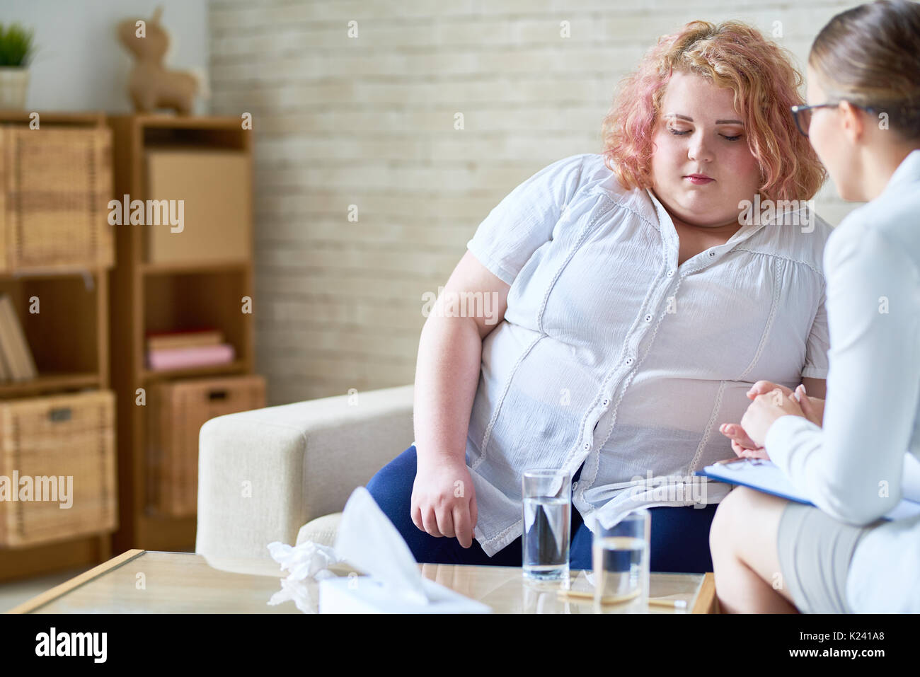 Obese Young Woman Talking to  Psychiatrist Stock Photo