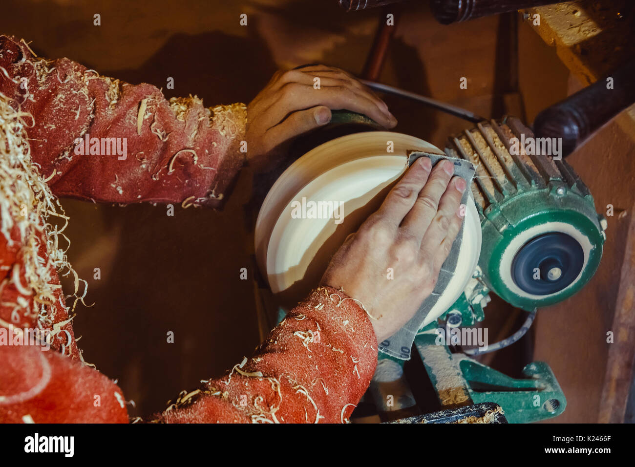 Wood turners using sandpaper polished wood on a lathe Stock Photo Alamy