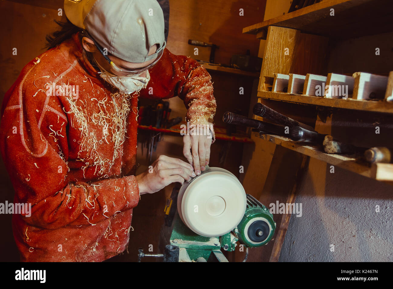 Wood turners using sandpaper polished wood on a lathe Stock Photo Alamy