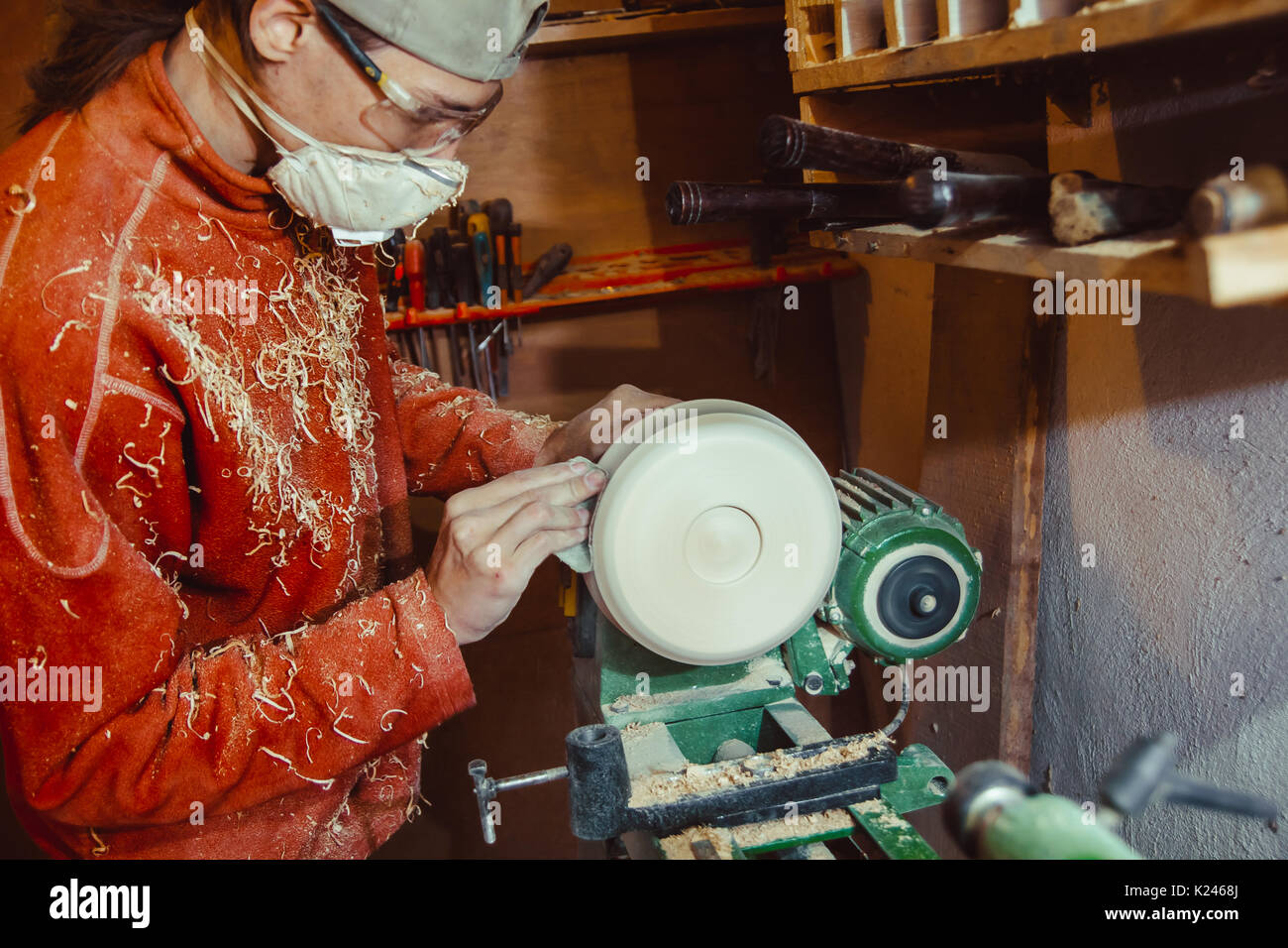 Wood turners using sandpaper polished wood on a lathe Stock Photo Alamy