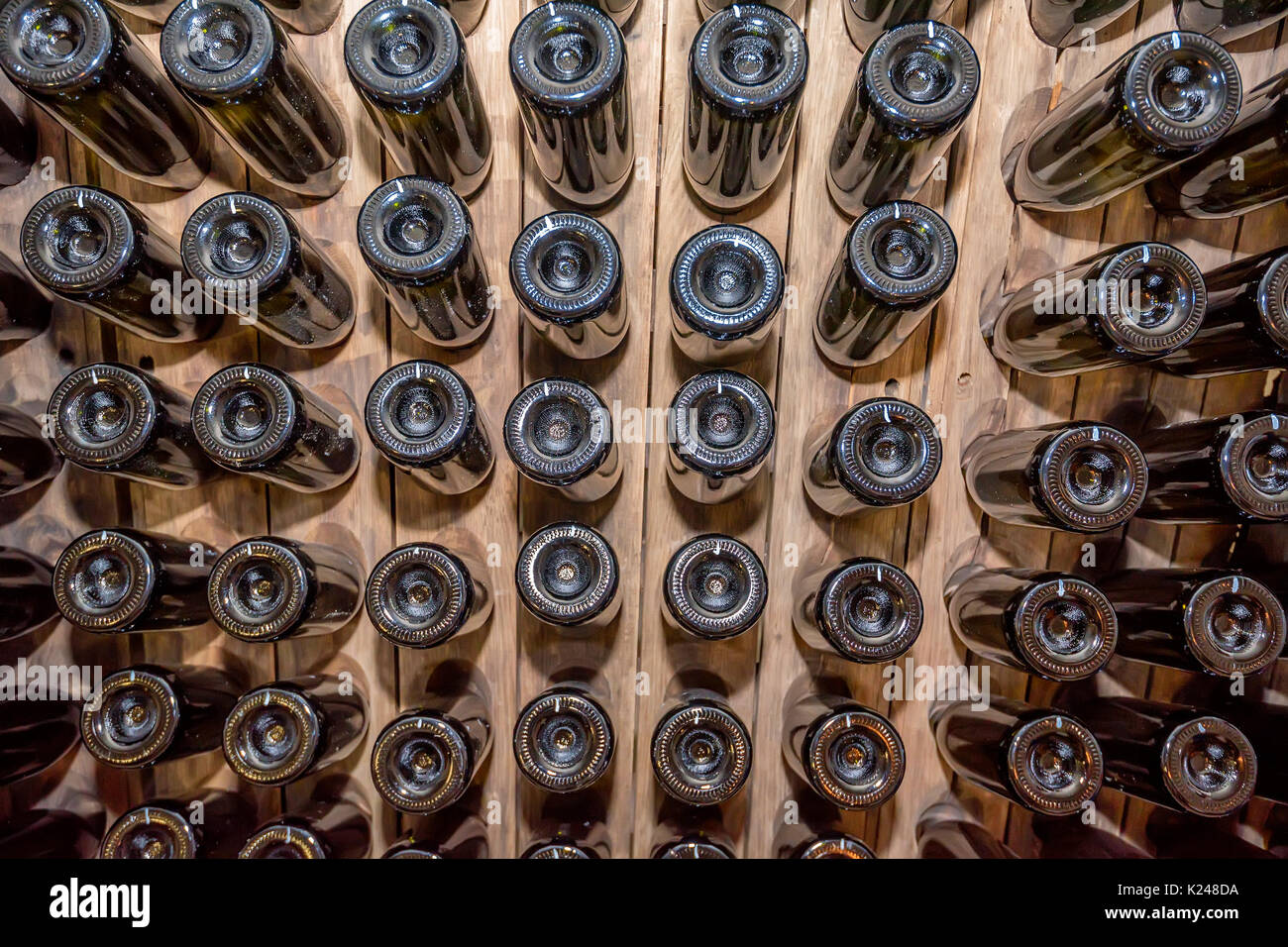 Bottoms of wine bottles stacked in cellar Stock Photo Alamy
