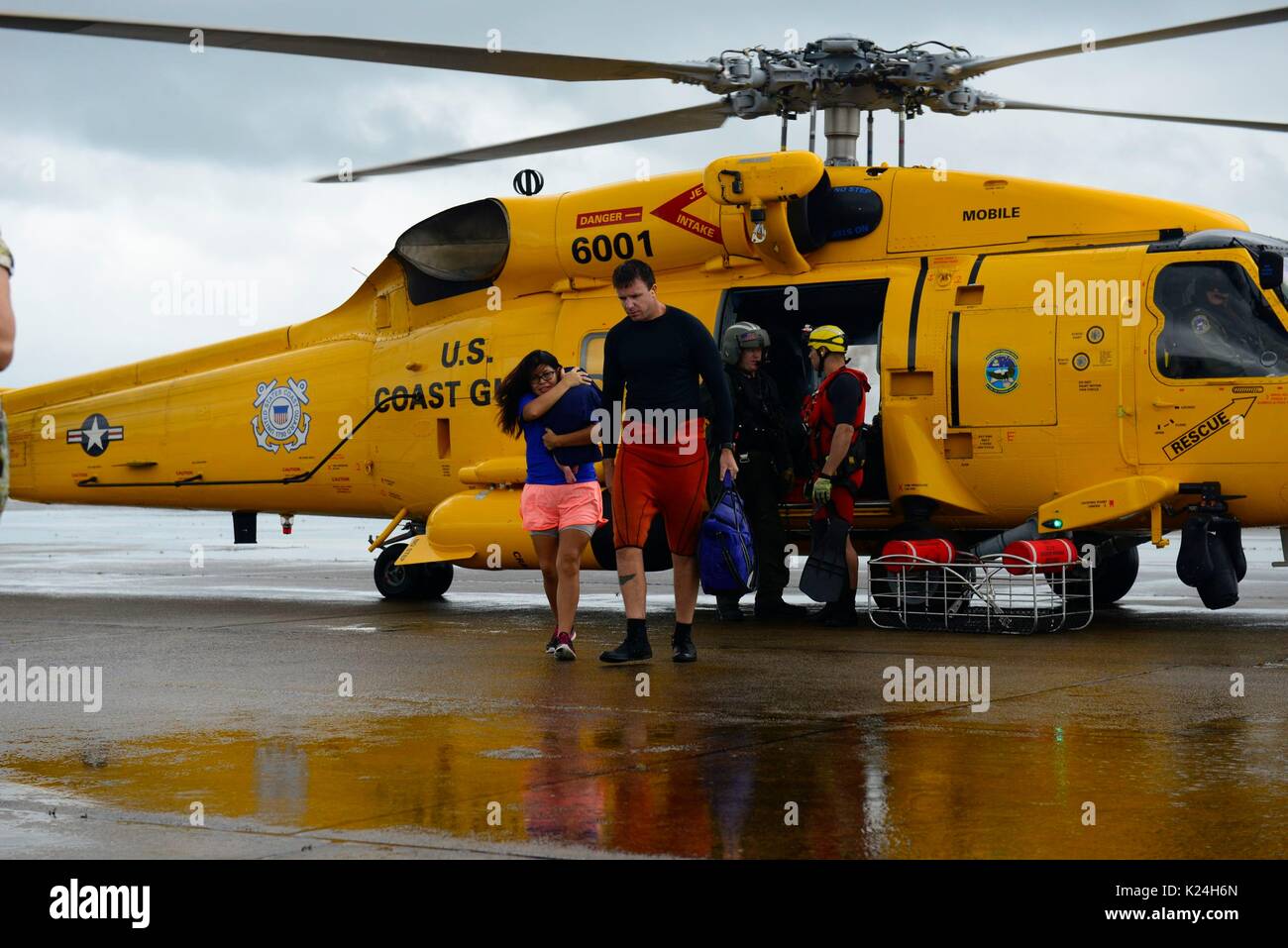 U.S. Coast Guard helicopter crews rescue stranded residents after massive flooding from record rains overwhelmed roads and buildings throughout the city in the aftermath of Hurricane Harvey August 27, 2016 in Houston, Texas. Stock Photo