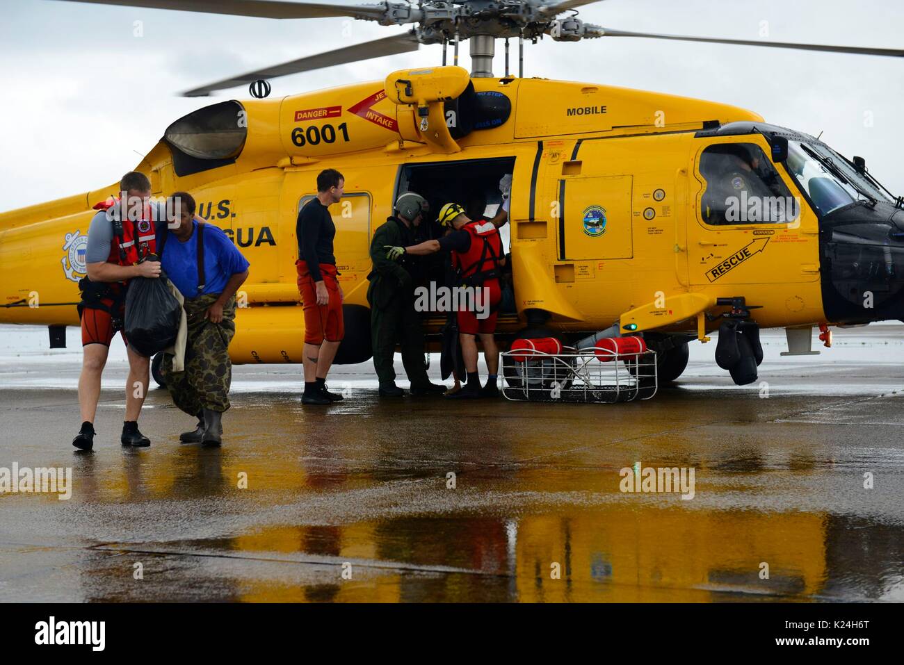 U.S. Coast Guard helicopter crews rescue stranded residents after massive flooding from record rains overwhelmed roads and buildings throughout the city in the aftermath of Hurricane Harvey August 27, 2016 in Houston, Texas. Stock Photo