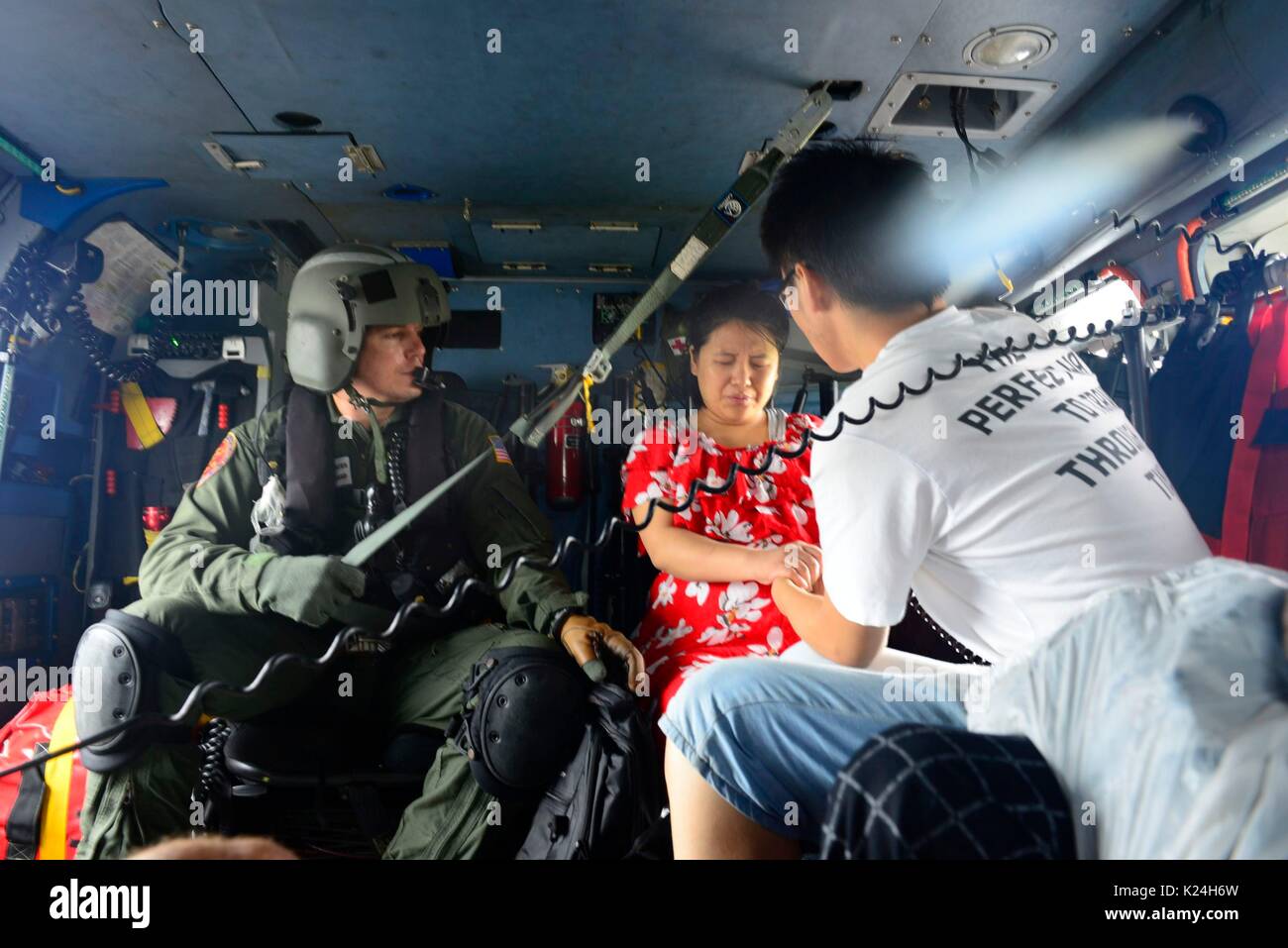 U.S. Coast Guard helicopter crews rescue stranded residents after massive flooding from record rains overwhelmed roads and buildings throughout the city in the aftermath of Hurricane Harvey August 27, 2016 in Houston, Texas. Stock Photo