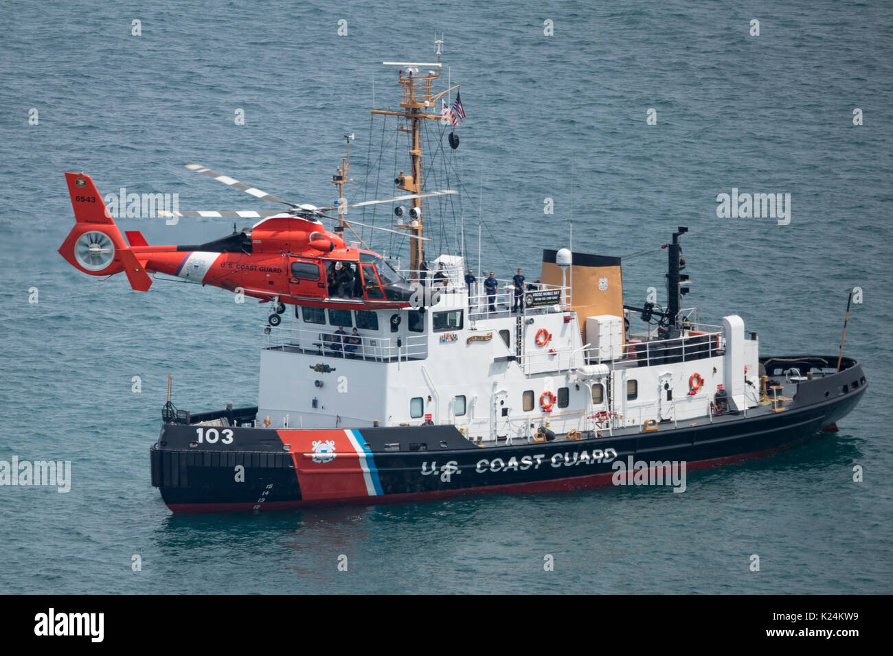 August 18, 2017: Chicago, Illinois, U.S. - A U.S. Coast Guard Helicopter MH-65 Dolphin flies past the USCG Mobile Bay in Lake Michigan during the practice for the 2017 Chicago Air and Water Show in Chicago, IL. Stock Photo