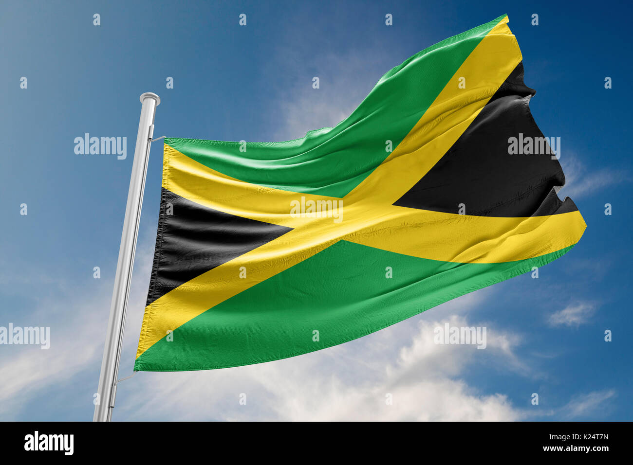 Jamaica flag is waving at a beautiful and peaceful sky in day time while sun is shining. 3D Rendering Stock Photo