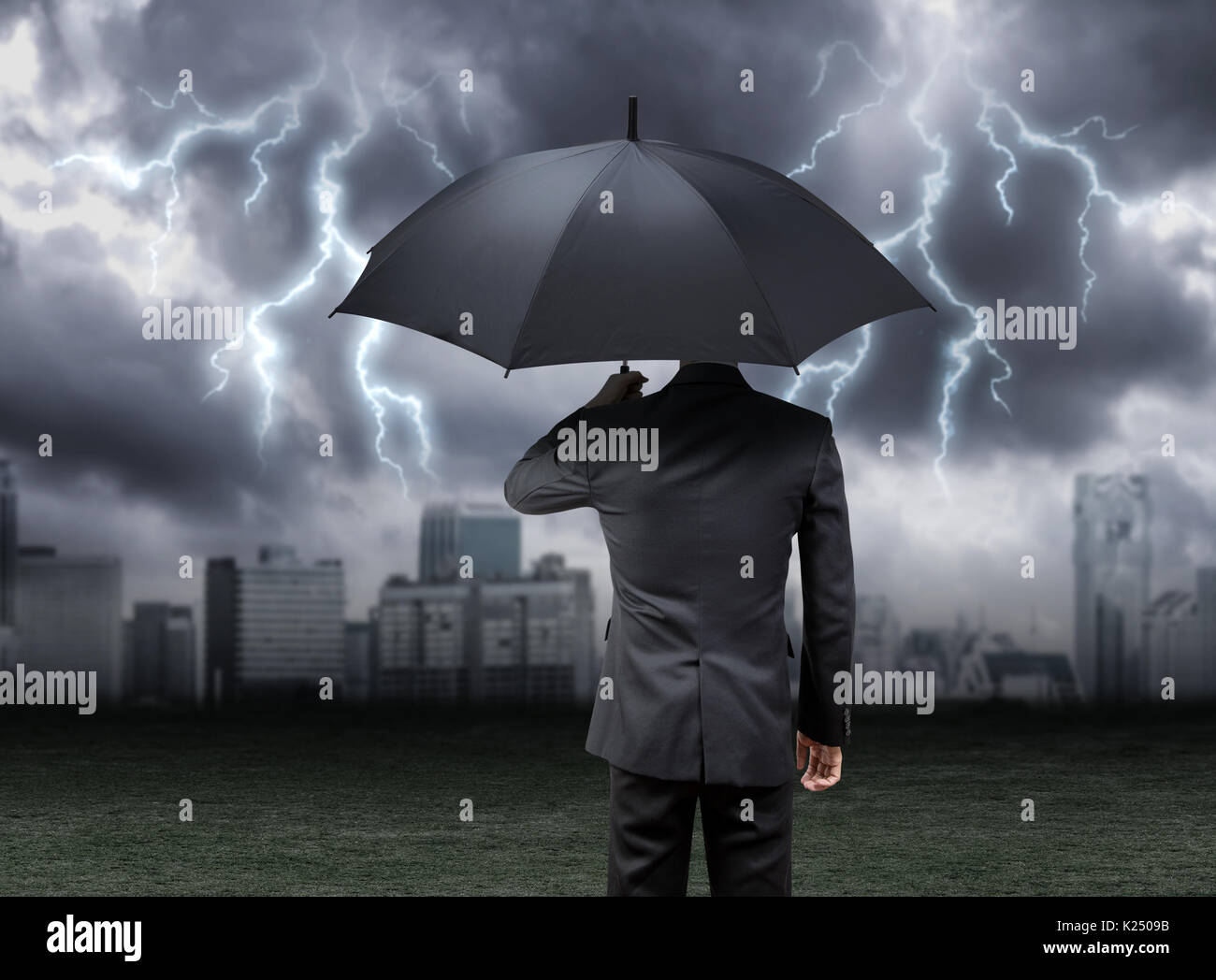 businessman hold umbrella under rain storm with city background Stock ...