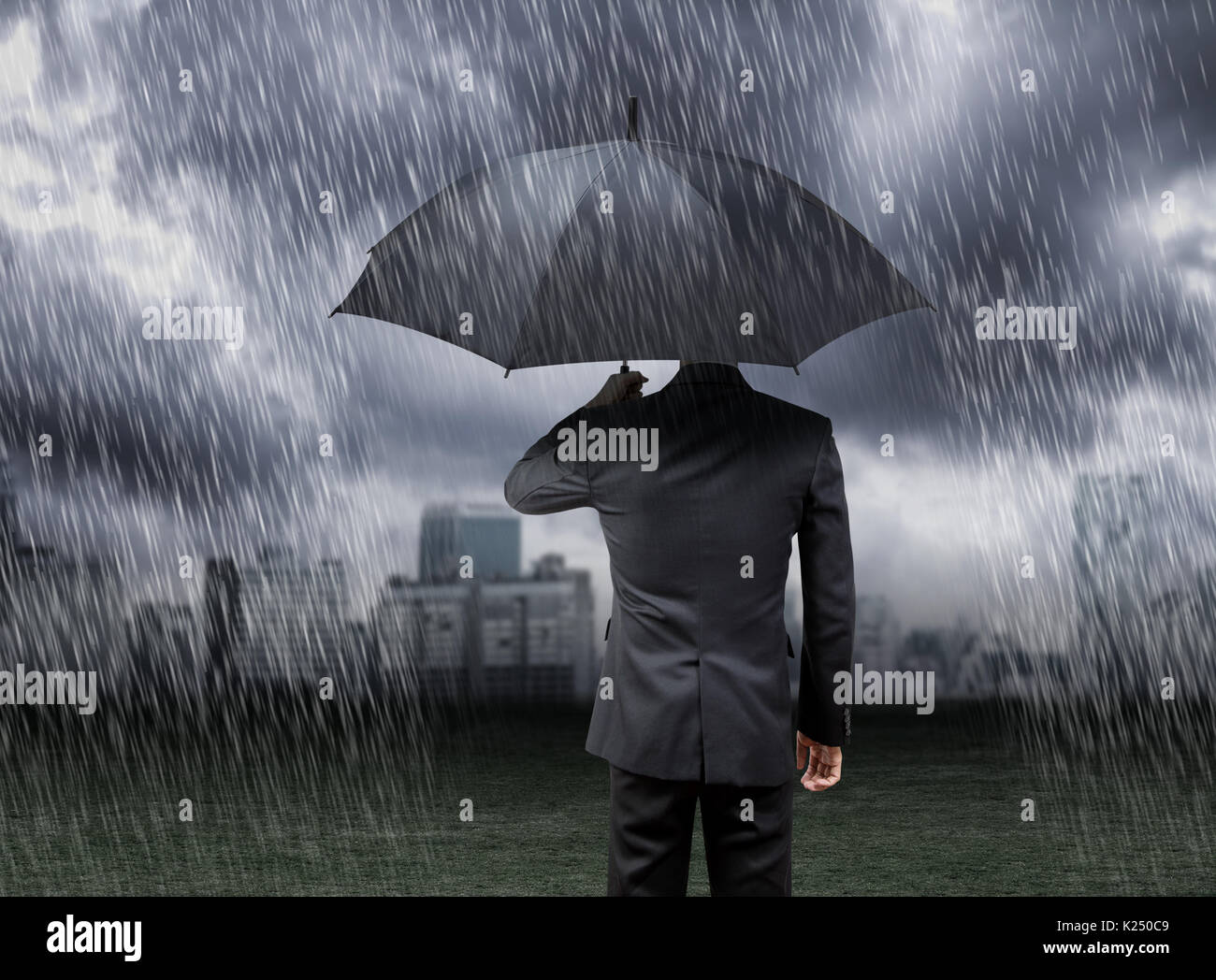 businessman hold umbrella under rain storm with city background Stock ...