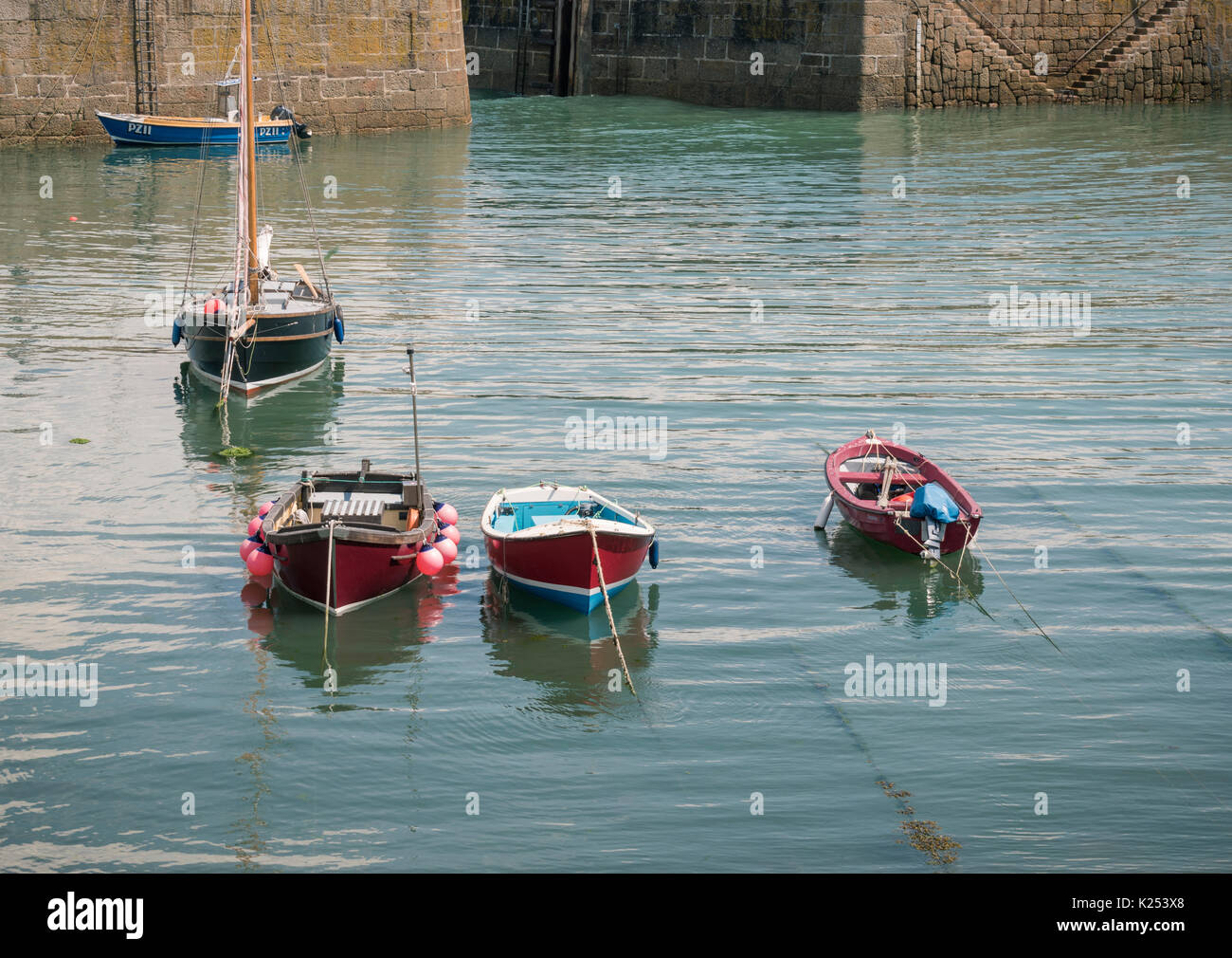 Boats in the Harbour at Low Tide in the Pretty Fishing Village of ...