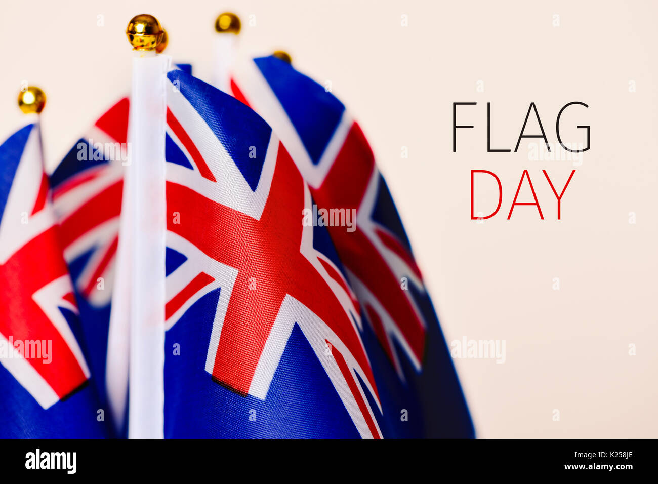 closeup of some australian flags and the text flag day against an off-white background Stock Photo