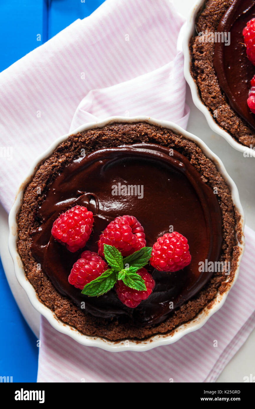 Chocolate raspberry tarts mint leaves Stock Photo
