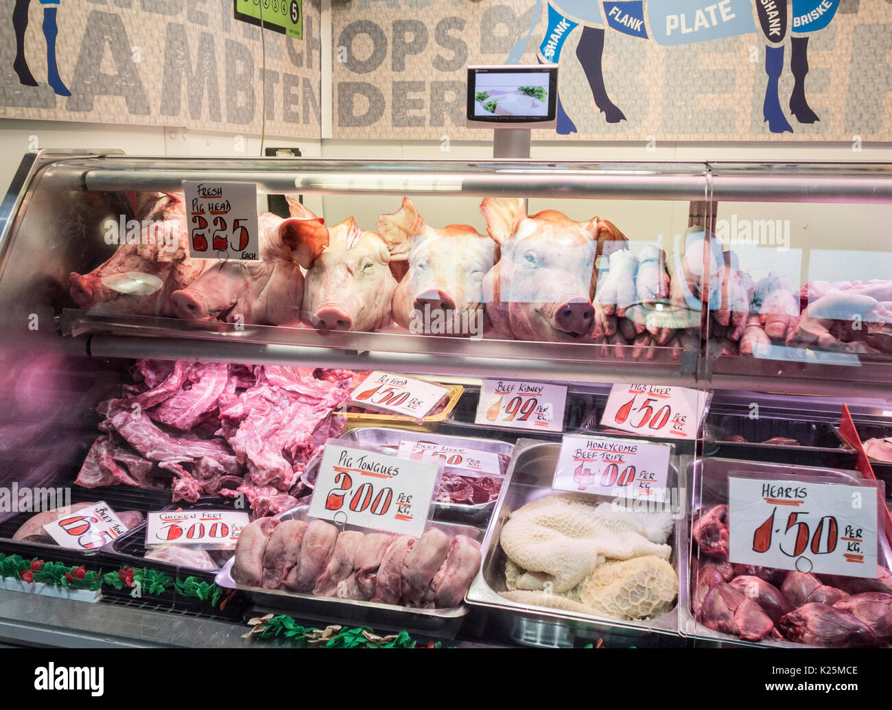 Pigs heads, tongues, trotters, tripe and chicken feet in Kirkgate indoor market in Leeds, Yorkshire, England, UK Stock Photo