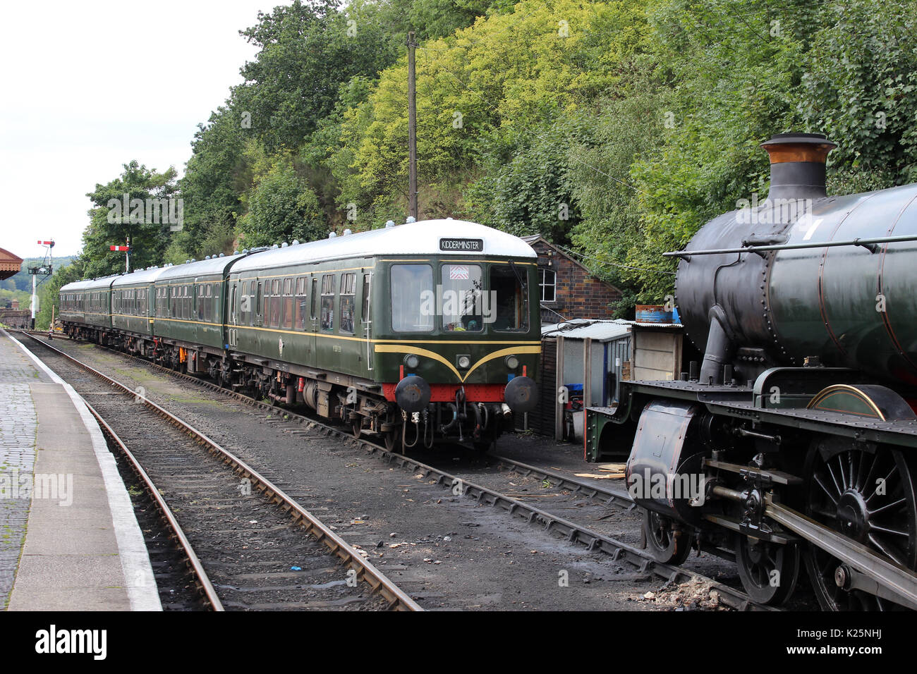 Two preserved heritage diesel multiple unit trains in BR green livery and steam train at Bewdley railway station on the Severn Valley Railway, England Stock Photo