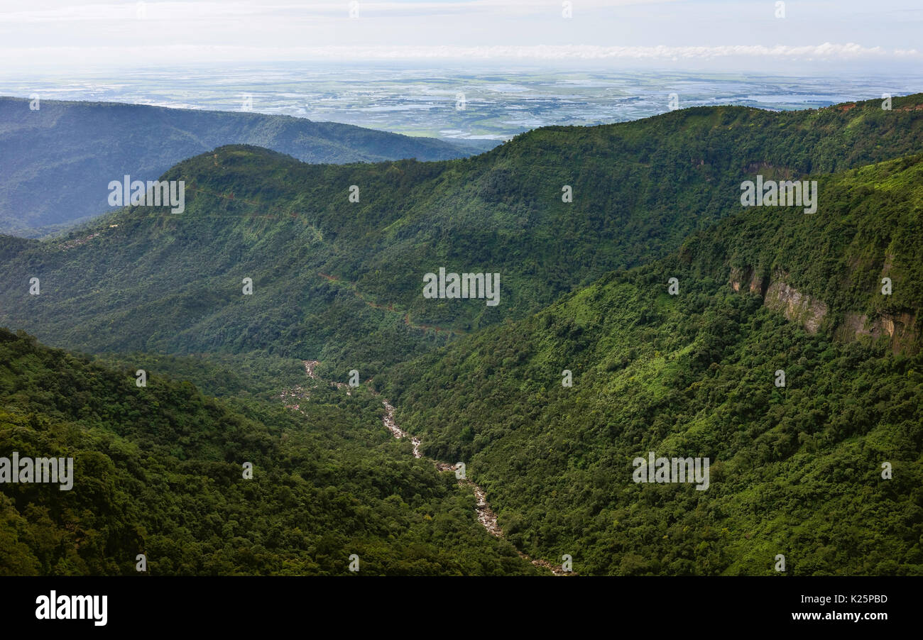 View along the Khasi hills and river with the rugged slopes of forest and peaks and the border with Bangladesh in Meghalaya, India. Stock Photo