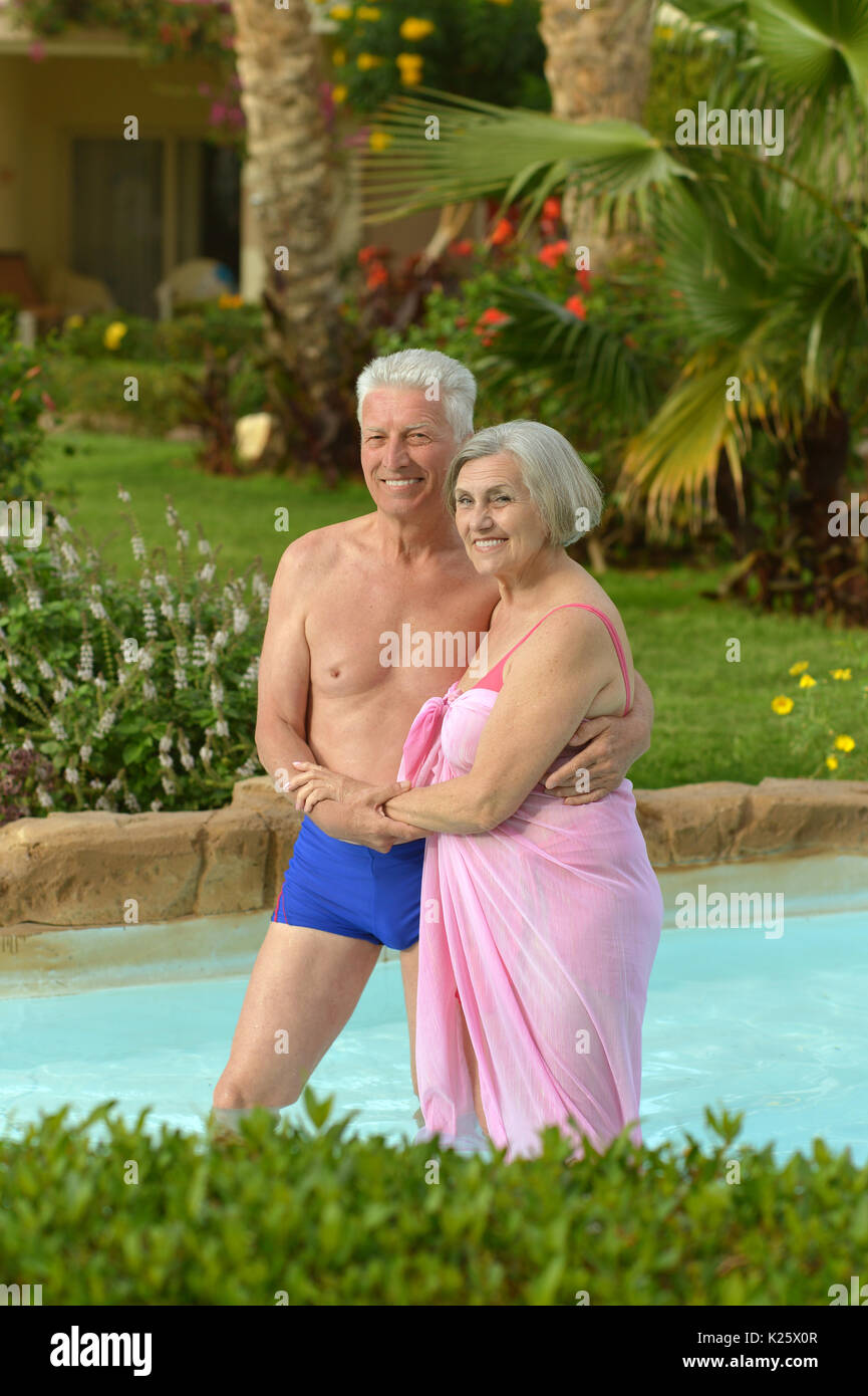 Portrait of a senior couple relaxing at pool Stock Photo - Alamy