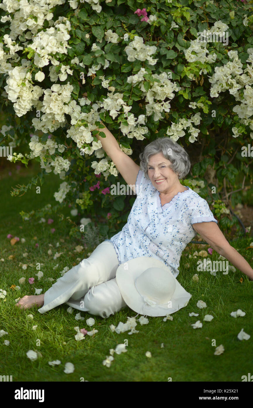 beautiful woman posing near tree with flowers outdoors Stock Photo - Alamy