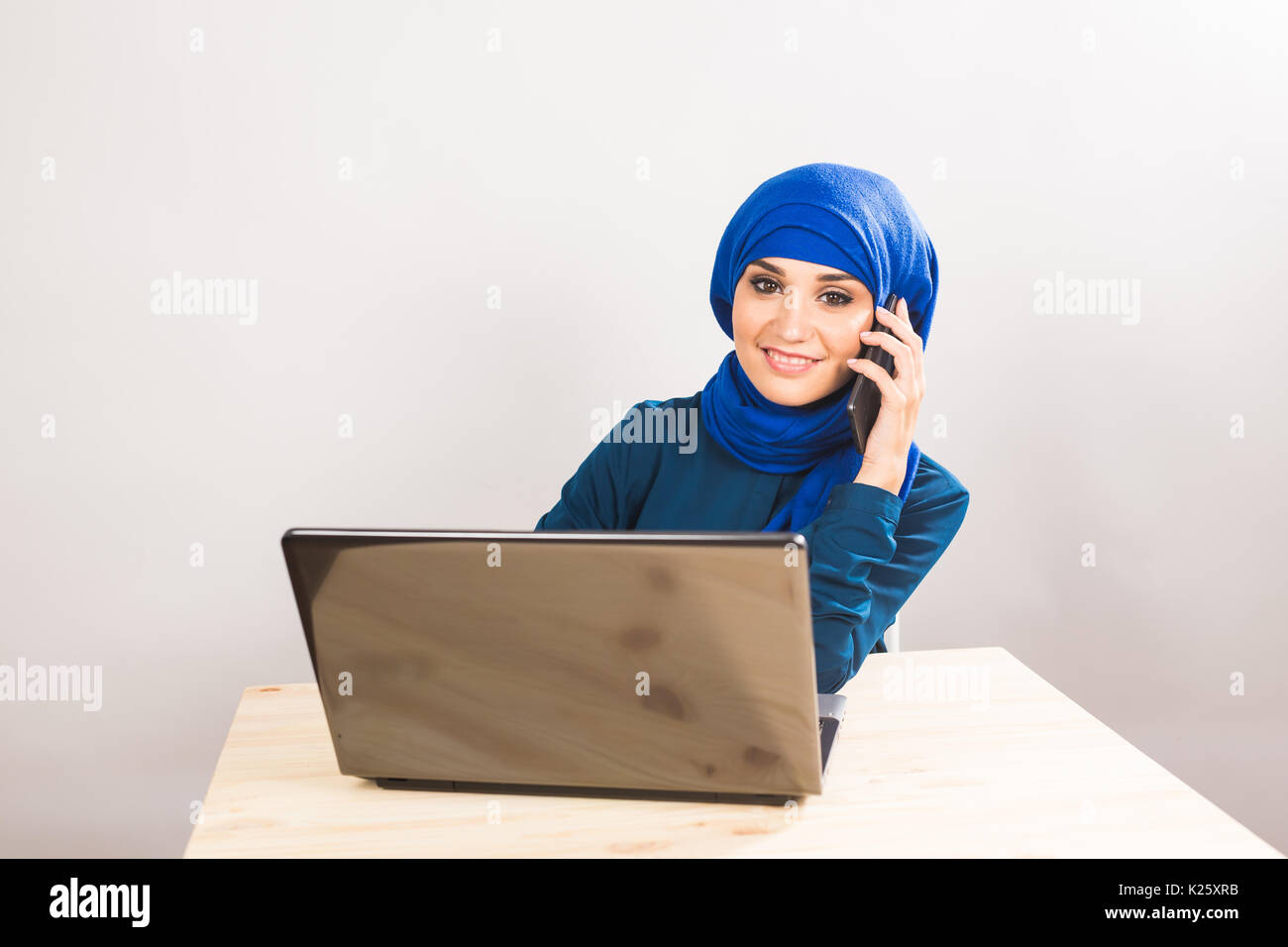 Beautiful young muslim business woman with laptop in office Stock Photo ...