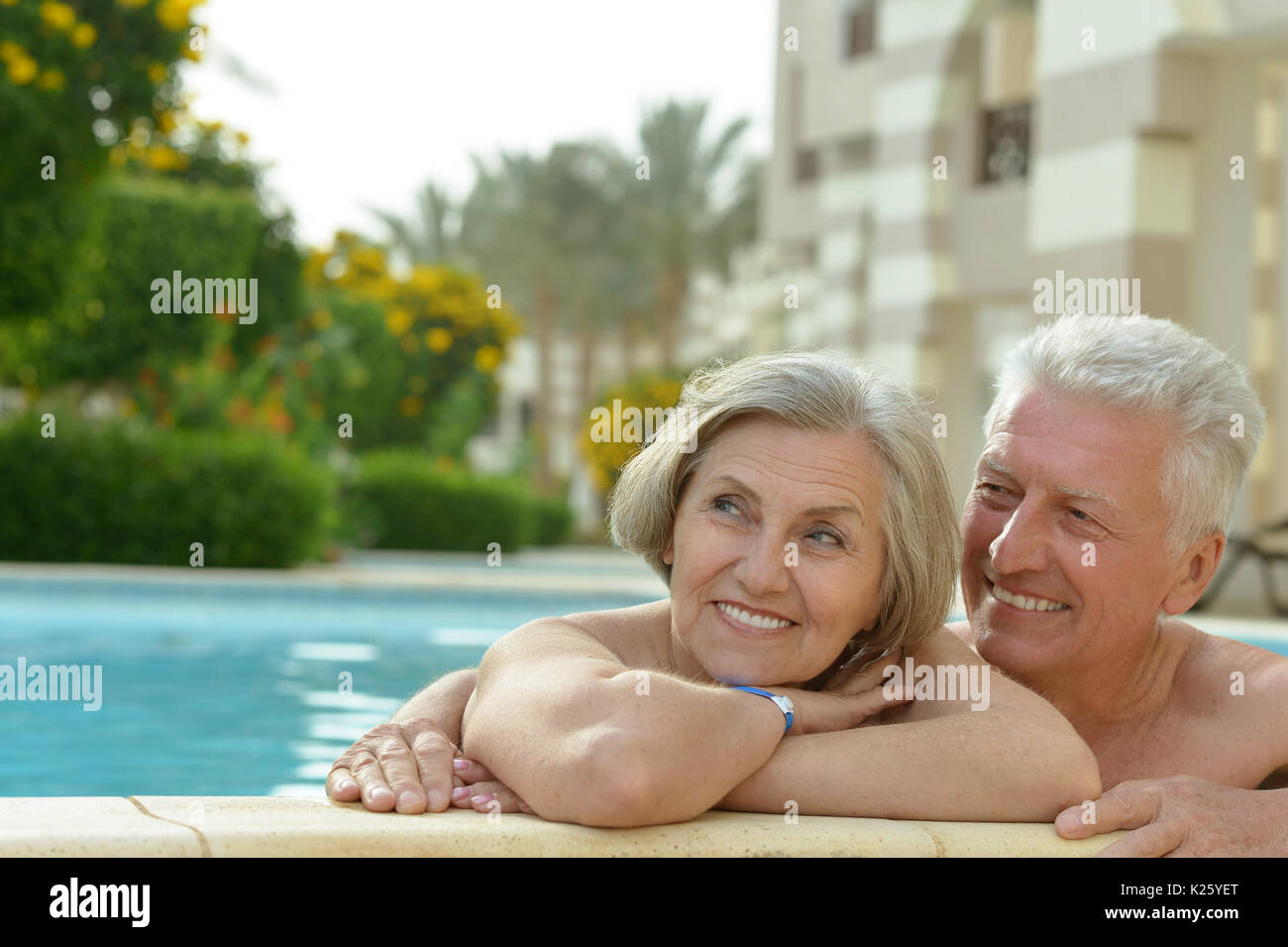 Portrait of a senior couple relaxing in pool Stock Photo - Alamy