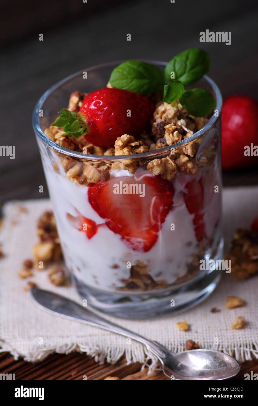 Glass with joghurt granola and strawberries Stock Photo