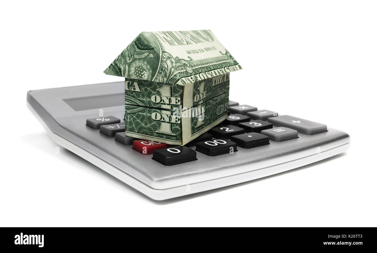 Calculator with origami house. Home equity with calculator and origami home. Stock Photo
