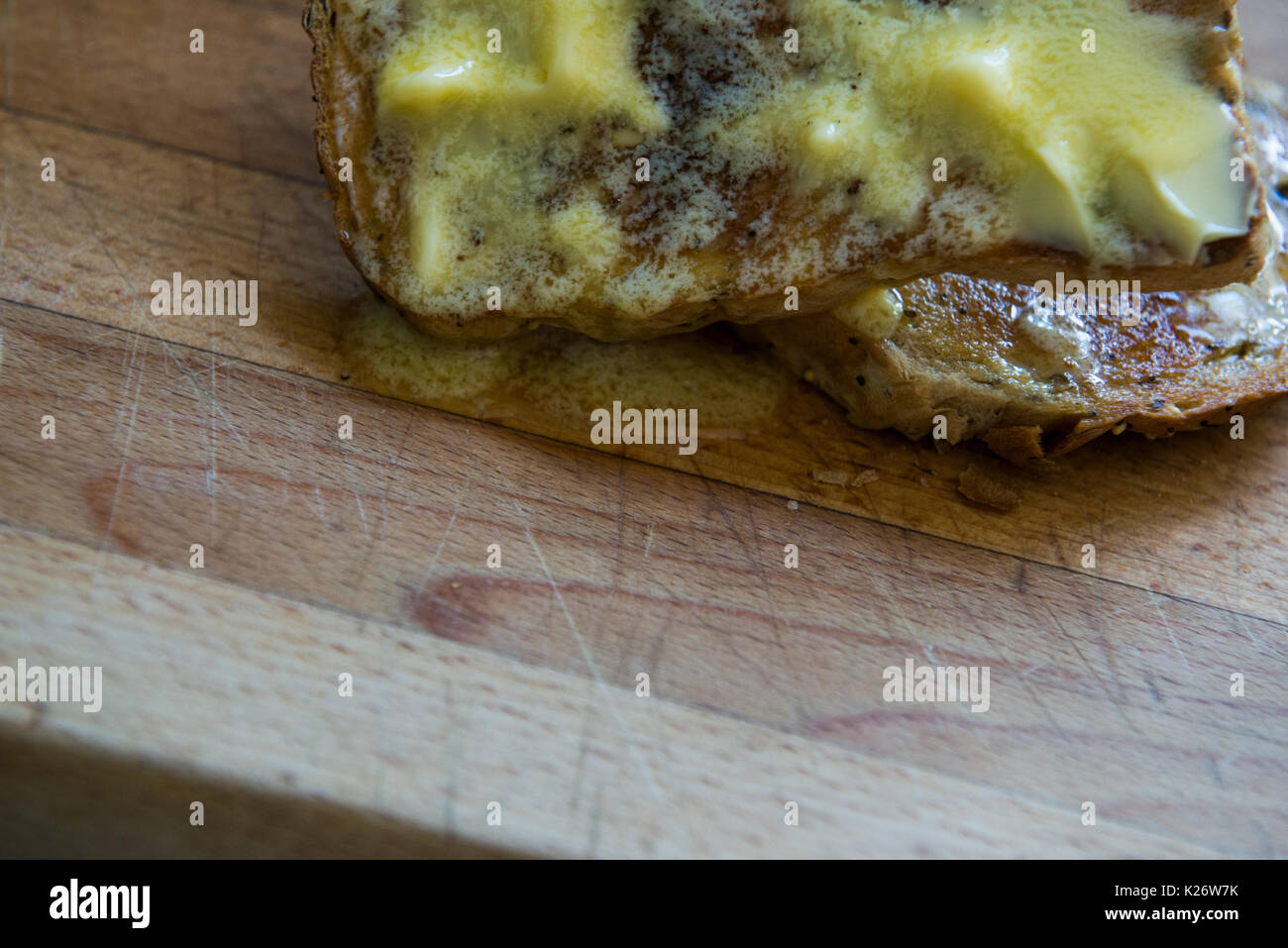Hot Buttered Toast on a Wooden Chopping Board Stock Photo