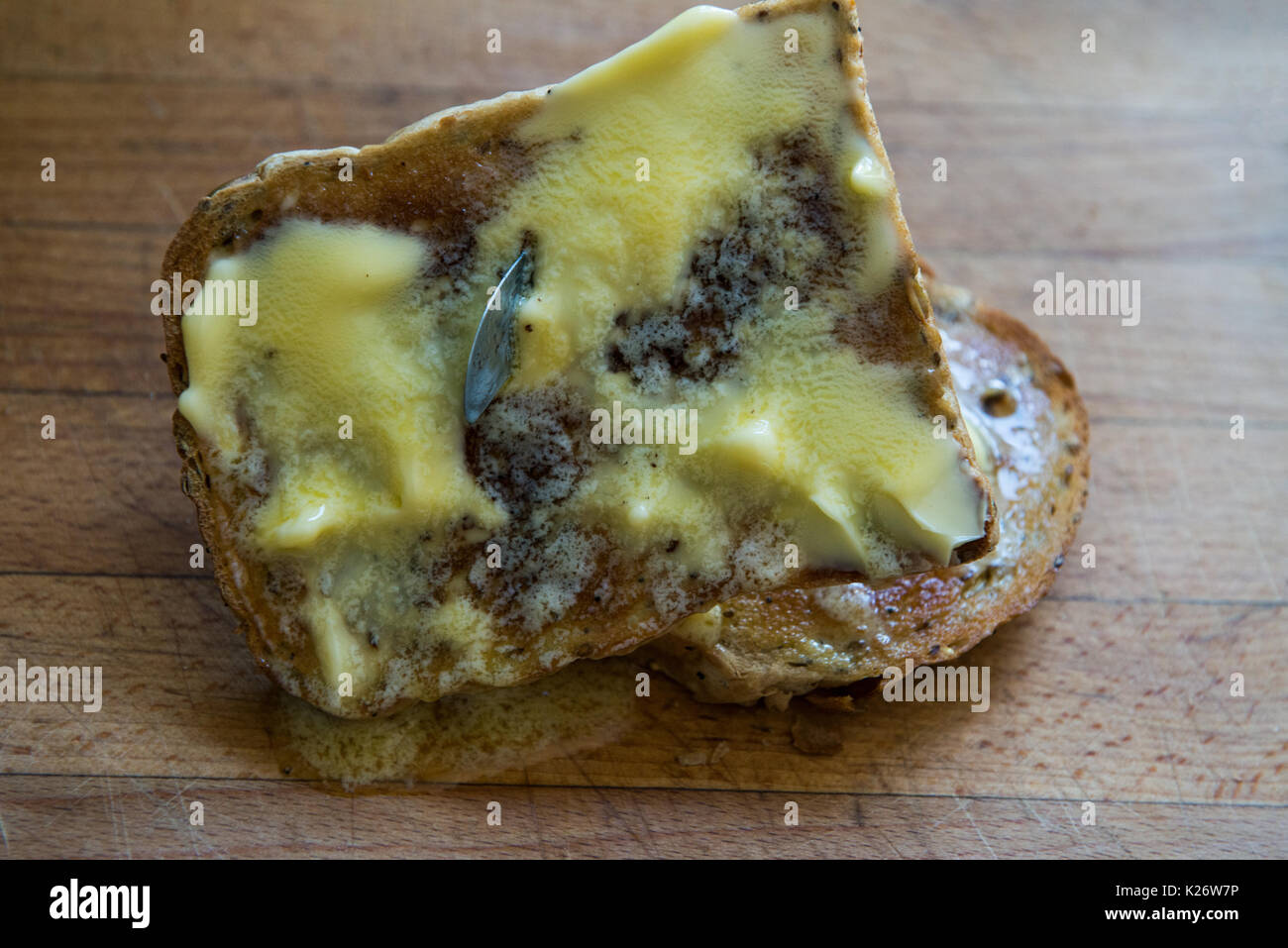 Hot Buttered Toast with Knife Plunged through it. Stock Photo