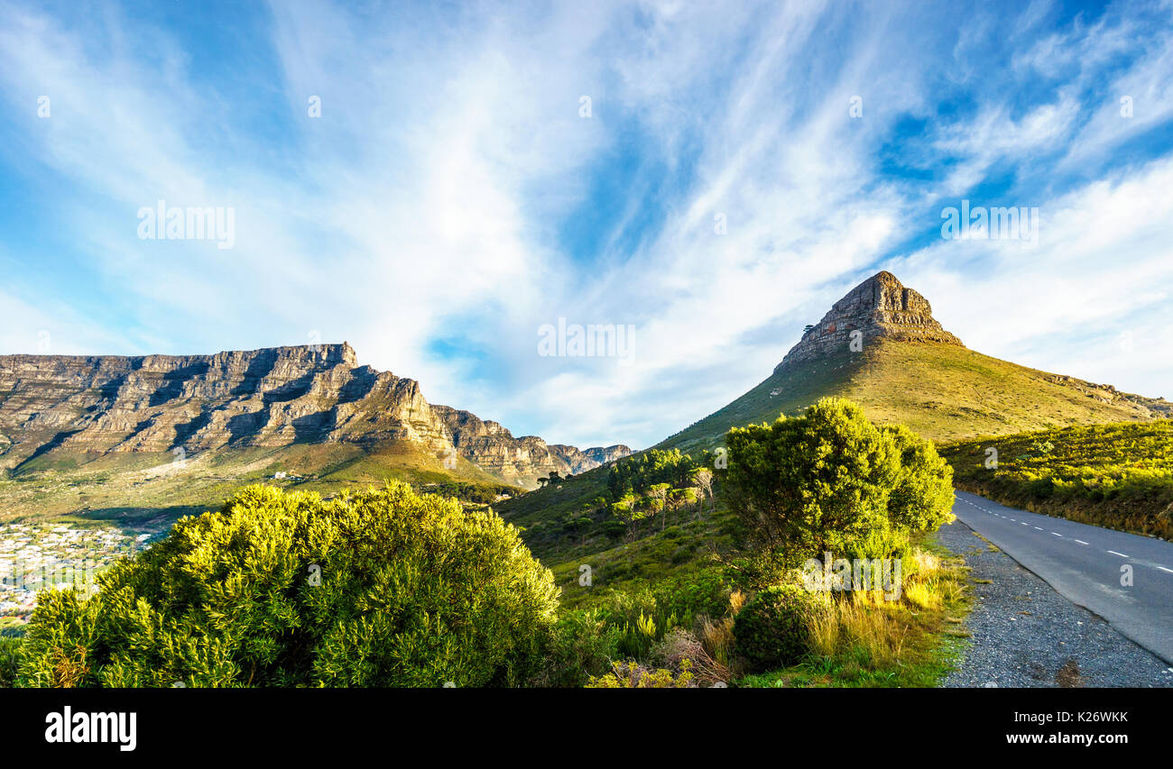 Sun setting over Table Mountain, Lions Head and the Twelve Apostles. Viewed from the road to Signal Hill at Cape Town, South Africa Stock Photo