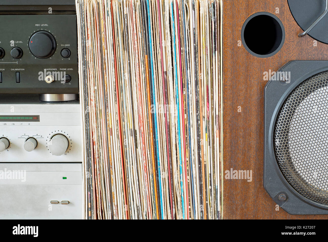 Retro receiver, amplifier stack of vinyl records near the sound speaker