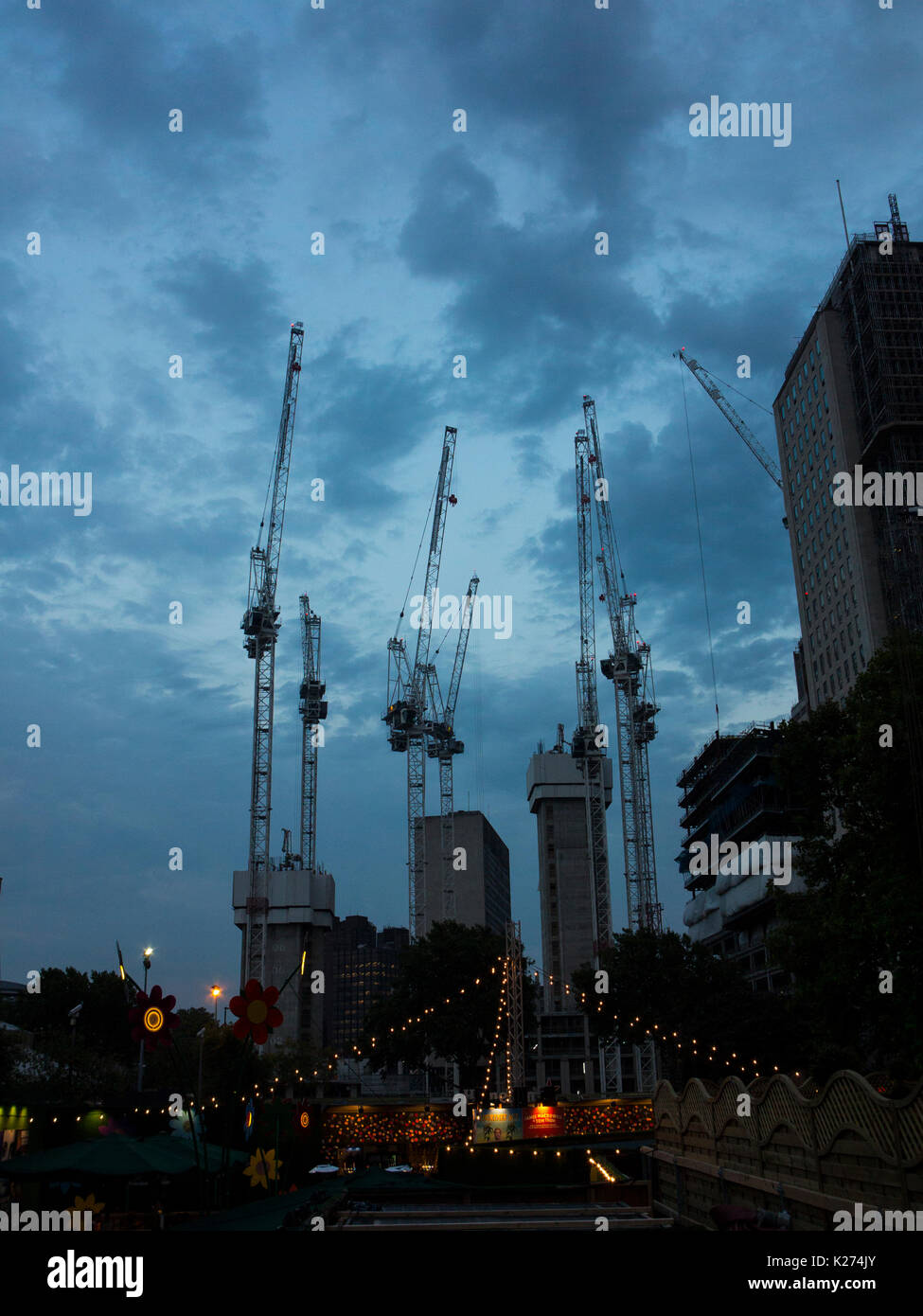 Cranes at dusk in London Stock Photo