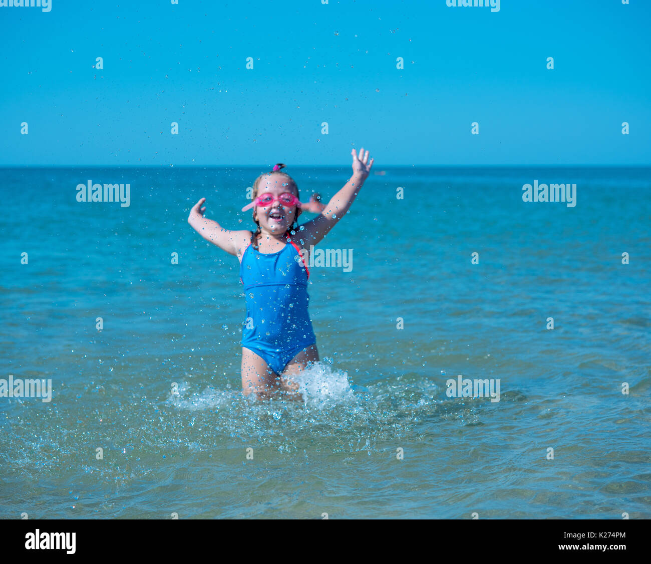 little girl playing in the sea Stock Photo - Alamy