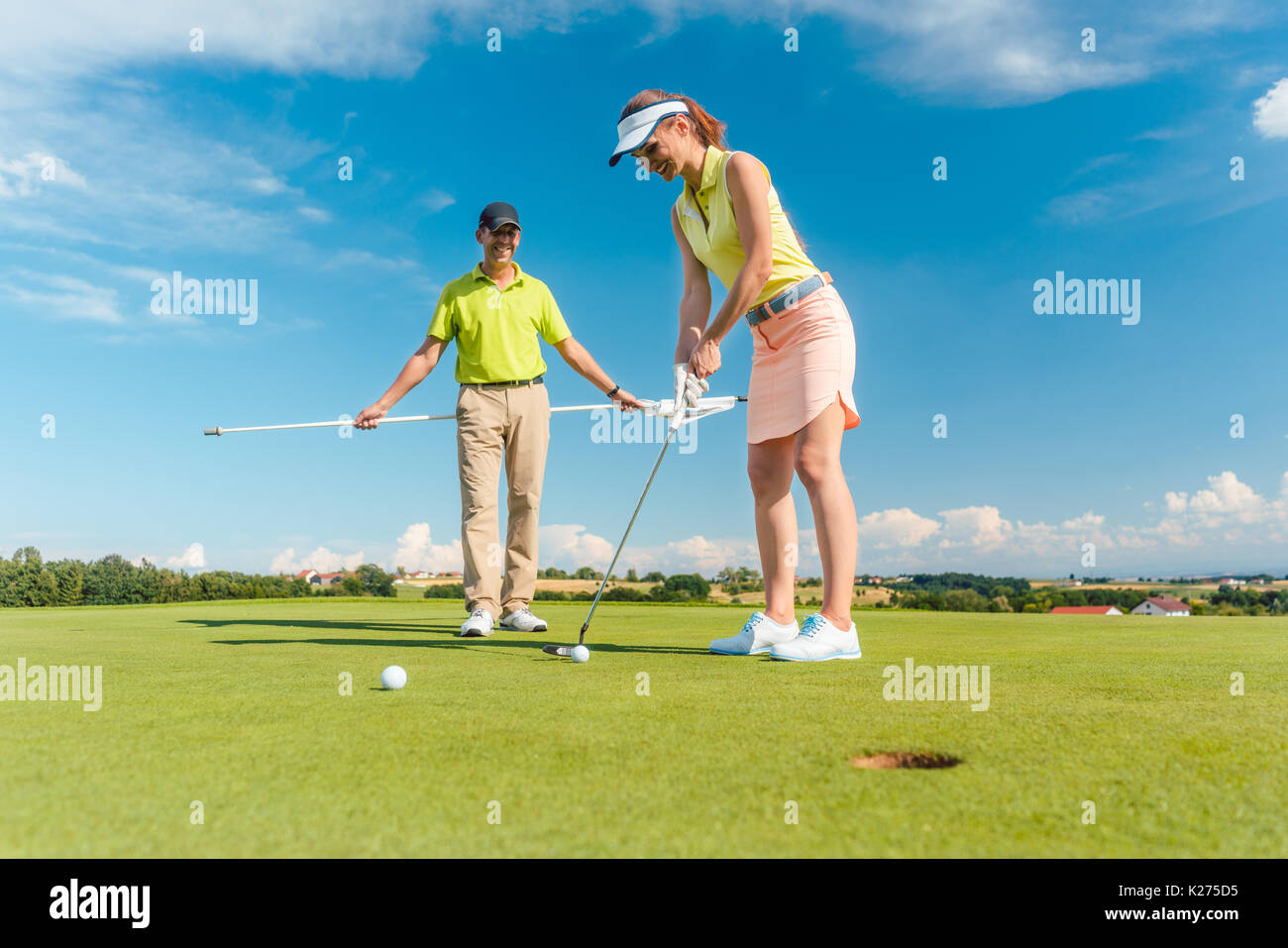 Full length of a woman playing professional golf with her male m Stock Photo