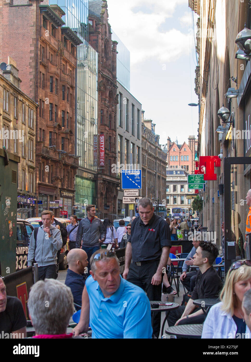 Crowds of people at outdoor cafe /bar in busy street in Glasgow, Scotland Stock Photo